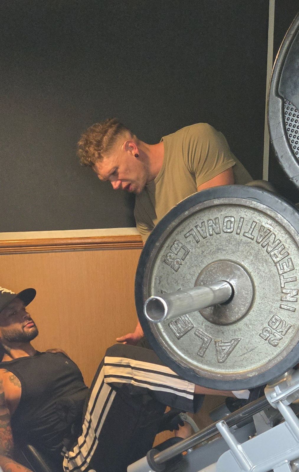 Matt coaching a client on the leg press