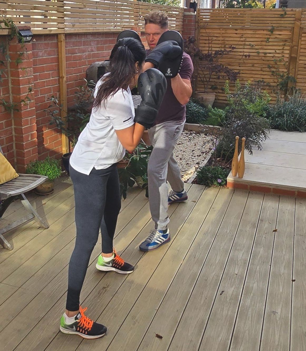 Matt coaching pad work with Dipti in the garden
