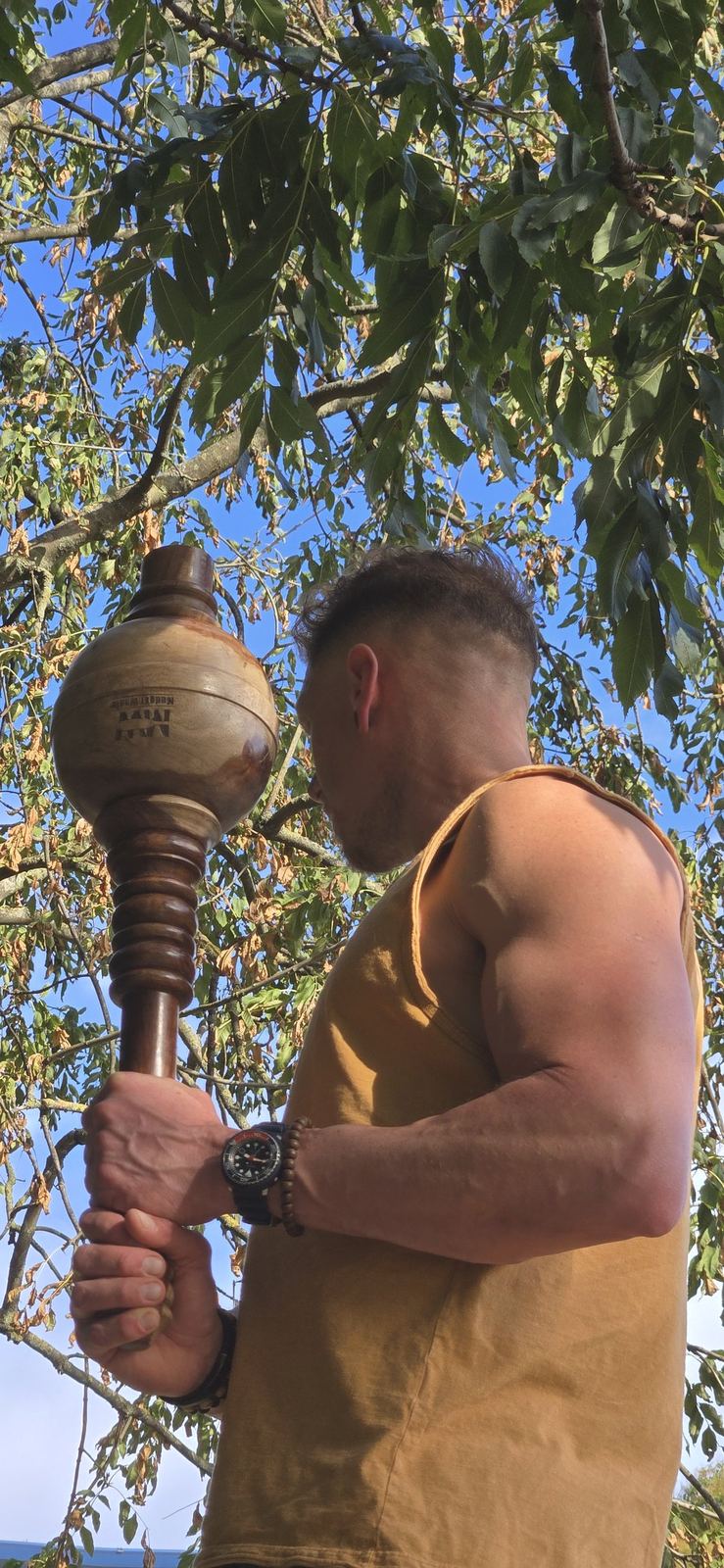 Matt training with a mace under a tree